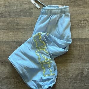 PINK Victoria's Secret Light Blue Kids Sweatpants with Yellow-Outlined Logo